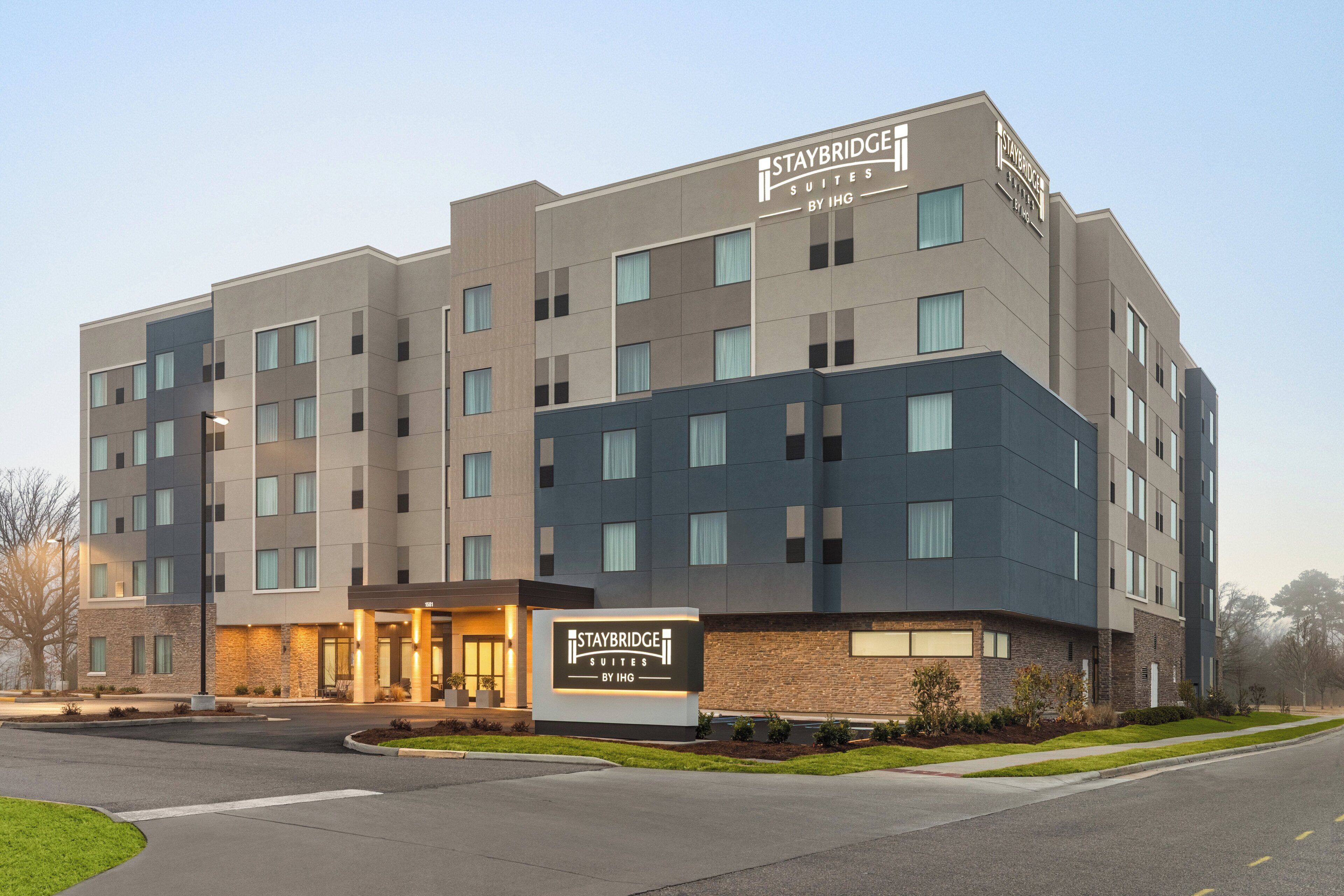 A Staybridge Suites hotel with a modern design, featuring a prominent entrance and multiple floors.
