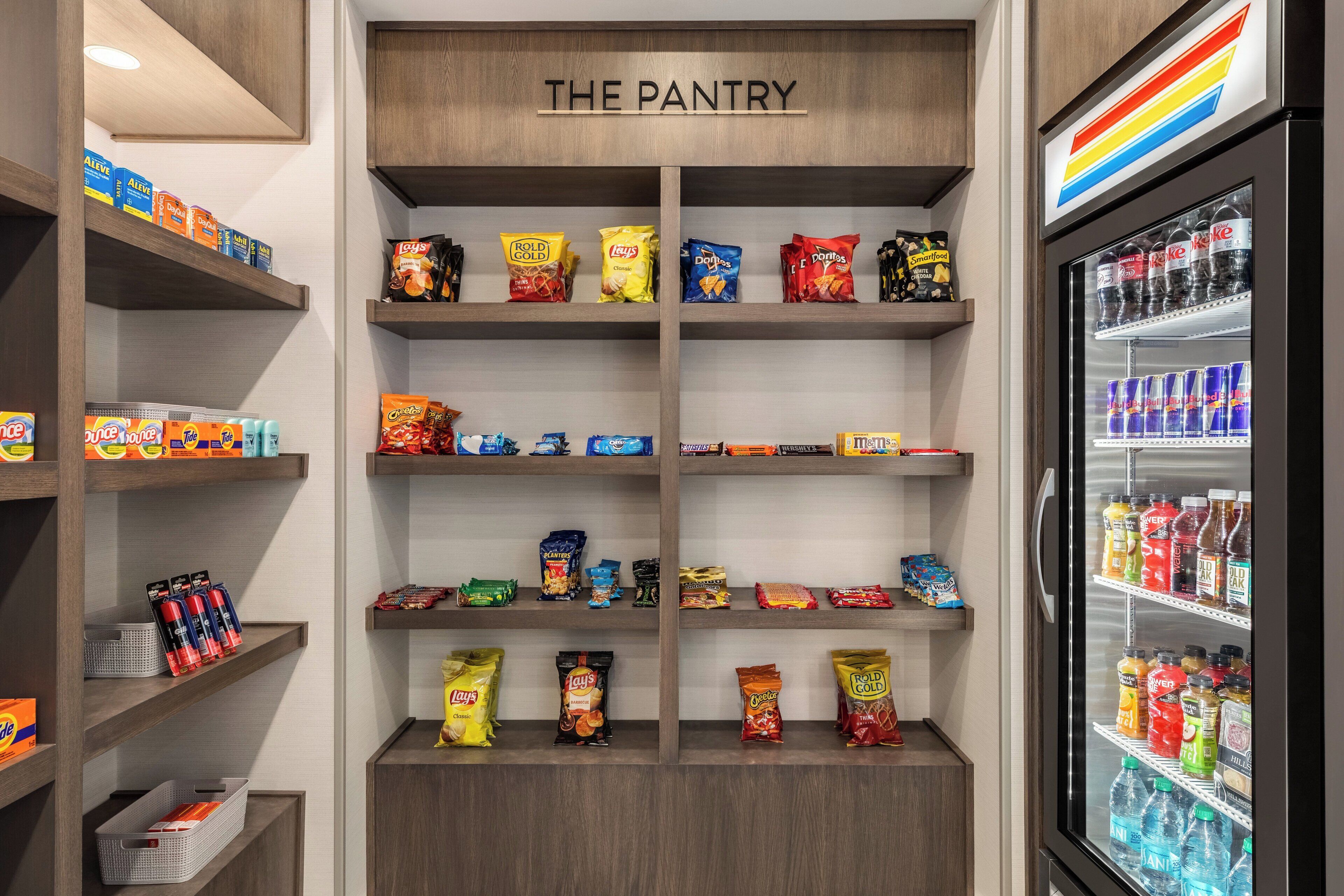 A pantry with shelves stocked with snacks and beverages.