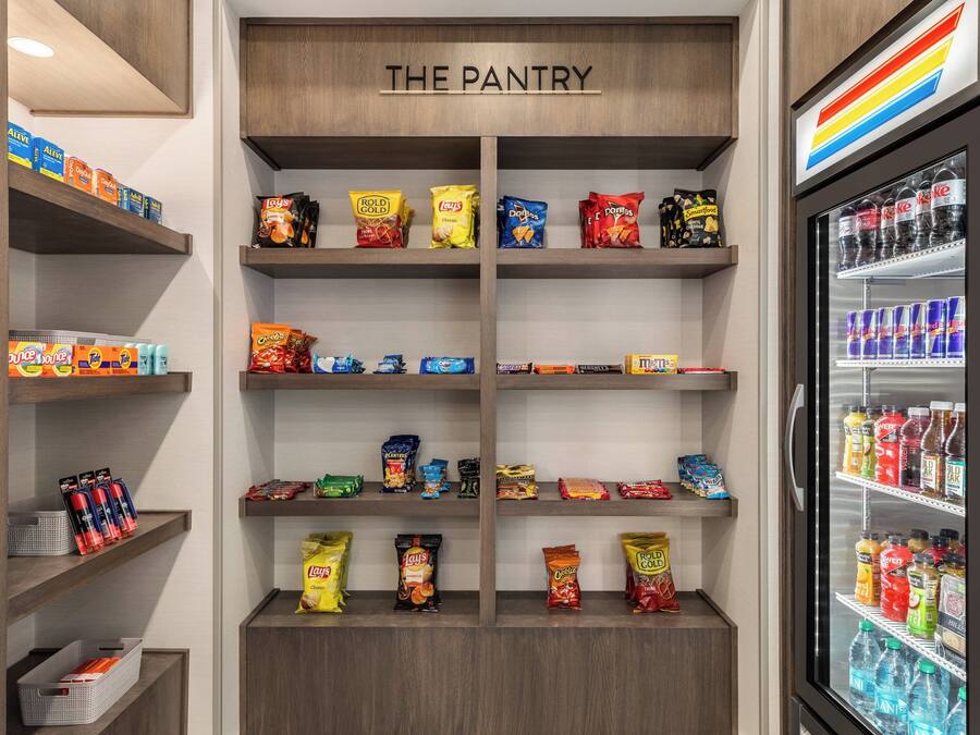 A pantry with shelves stocked with snacks and beverages.