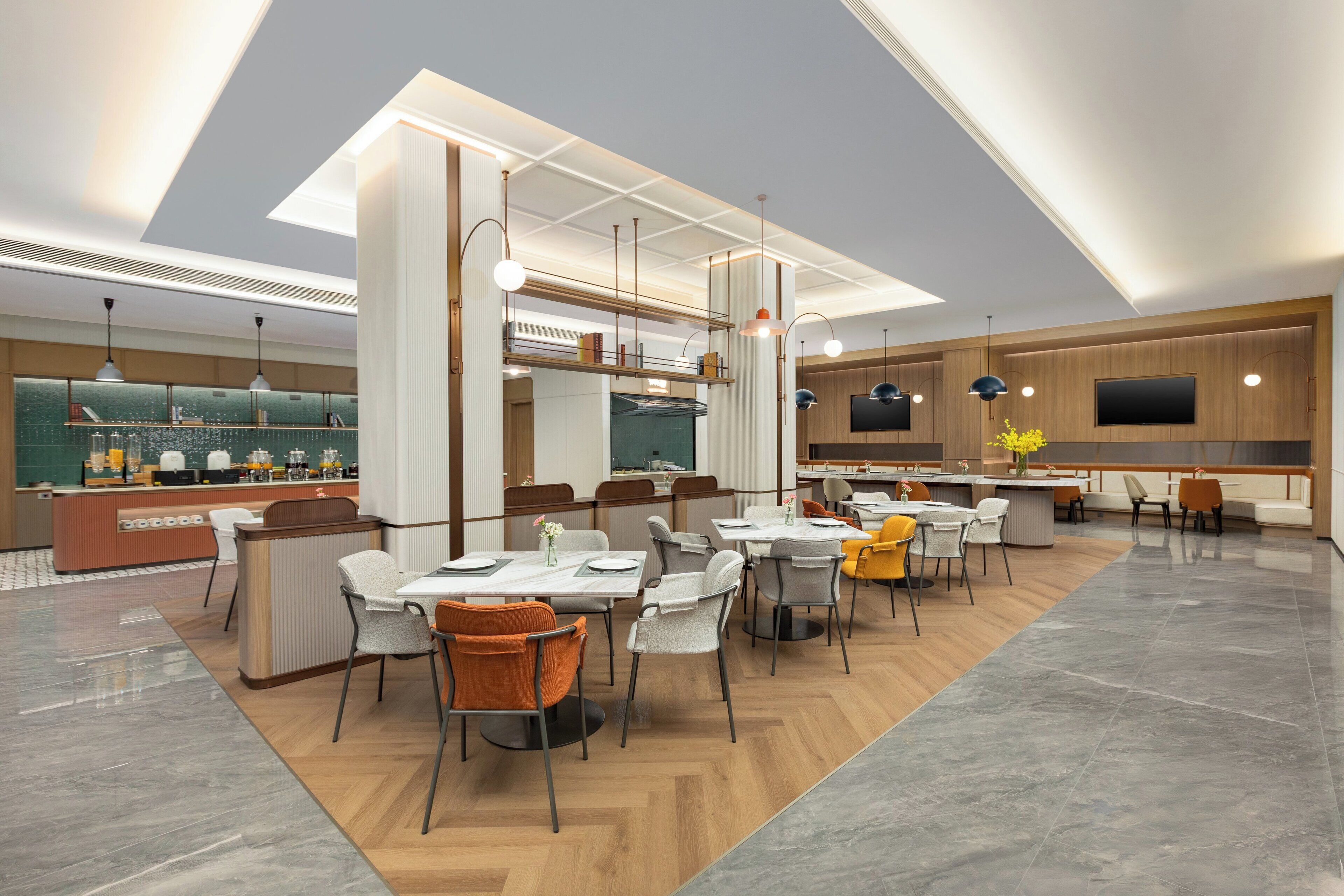A modern restaurant with a central bar, multiple dining tables, and a variety of chairs.