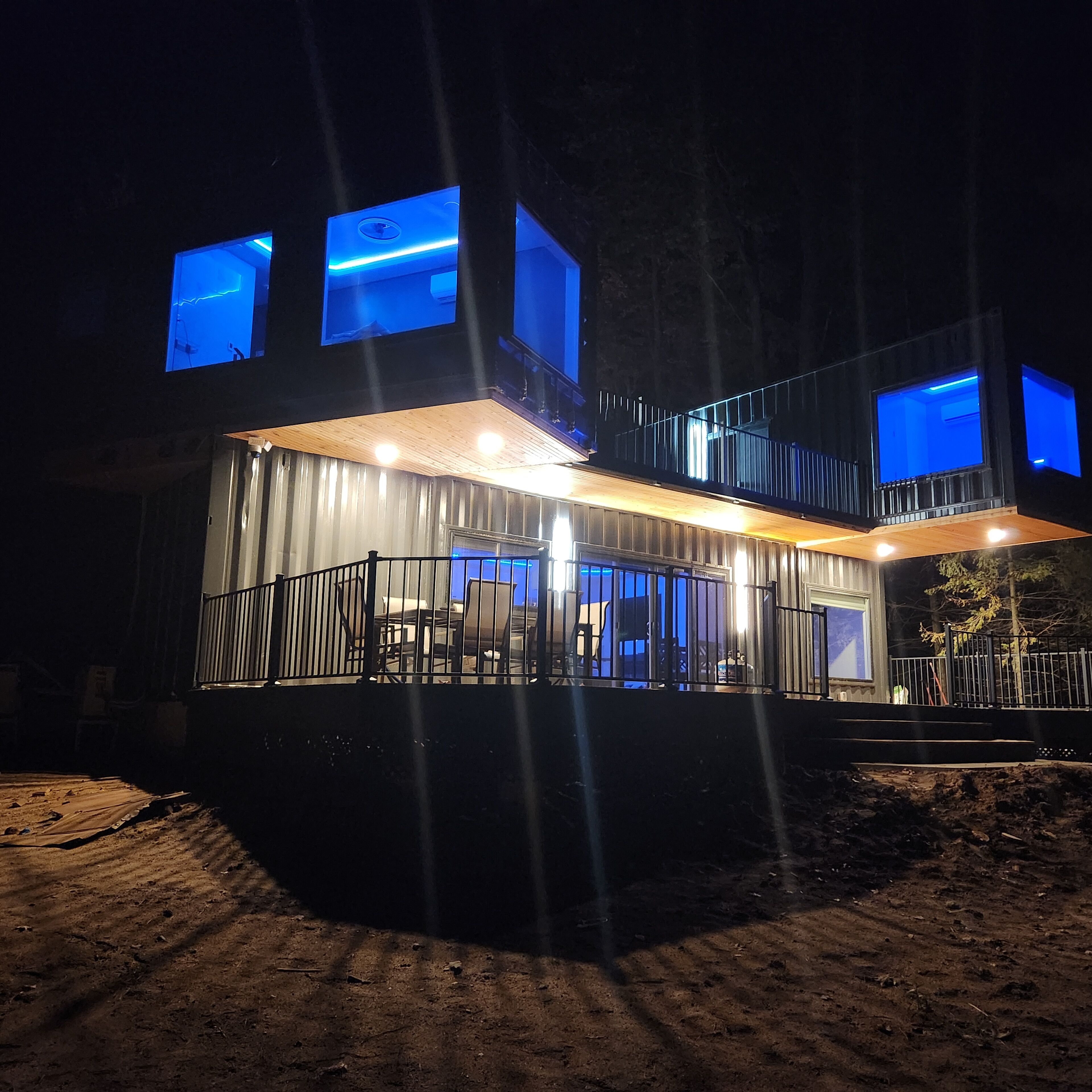 Een modern gebouw met twee verdiepingen, grote ramen en een balkon.
