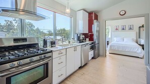 A modern kitchen with a gas stove, a coffee maker, and a refrigerator. - 1 BR Guest House, Full Kitchen, 3-minutes to Downtown Austin! (Austin)