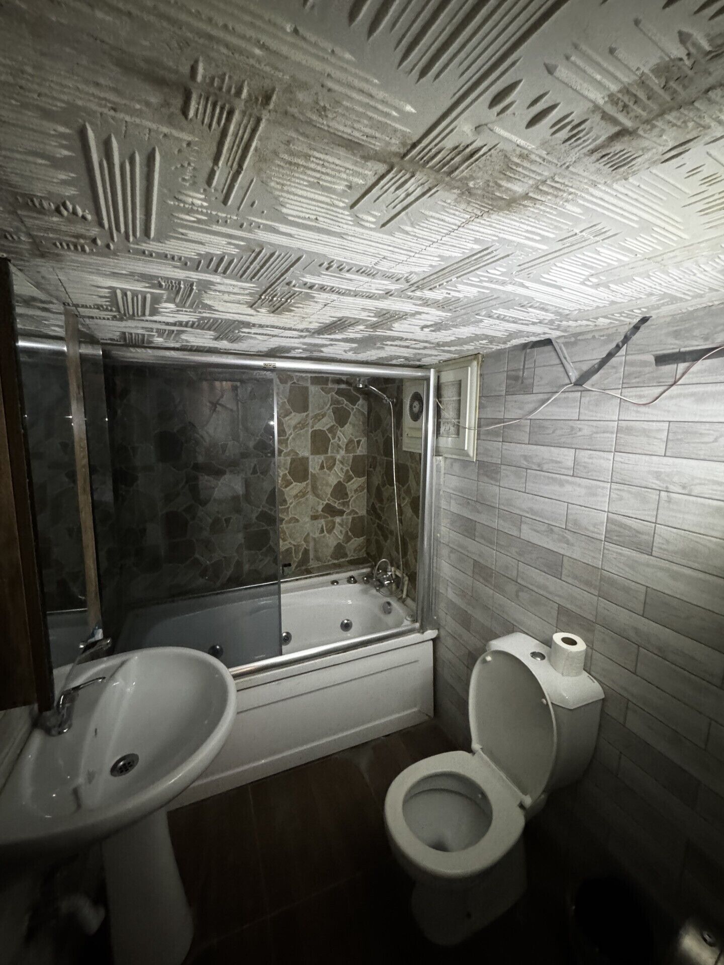 A bathroom with a bathtub, a sink, and a toilet.