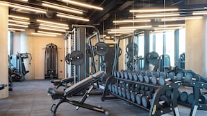 A gym with weightlifting equipment, treadmills, and dumbbells. - Enclave Croydon - Campus Accommodation (Croydon)