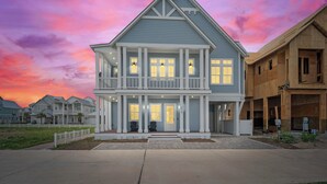 A two-story house with a balcony, a porch, and a garage. - Beaches and Cream 210 DEW (Port Aransas)