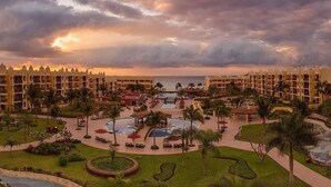 A resort with multiple buildings, a central pool area, and palm trees. - The Royal Haciendas All Suites Resort (Playa del Carmen)