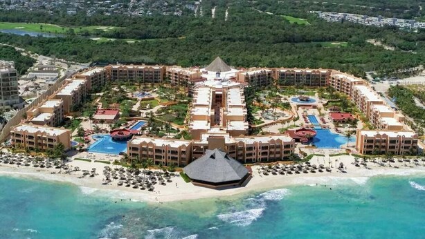 A resort with multiple buildings, a central pool, and a beach area. - The Royal Haciendas All Suites Resort (Playa del Carmen)