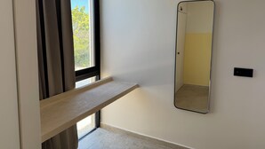 A room with a window, a mirror, and a light fixture. - KatNap Sisal : Solar-powered Beachfront Retreat (Sisal)