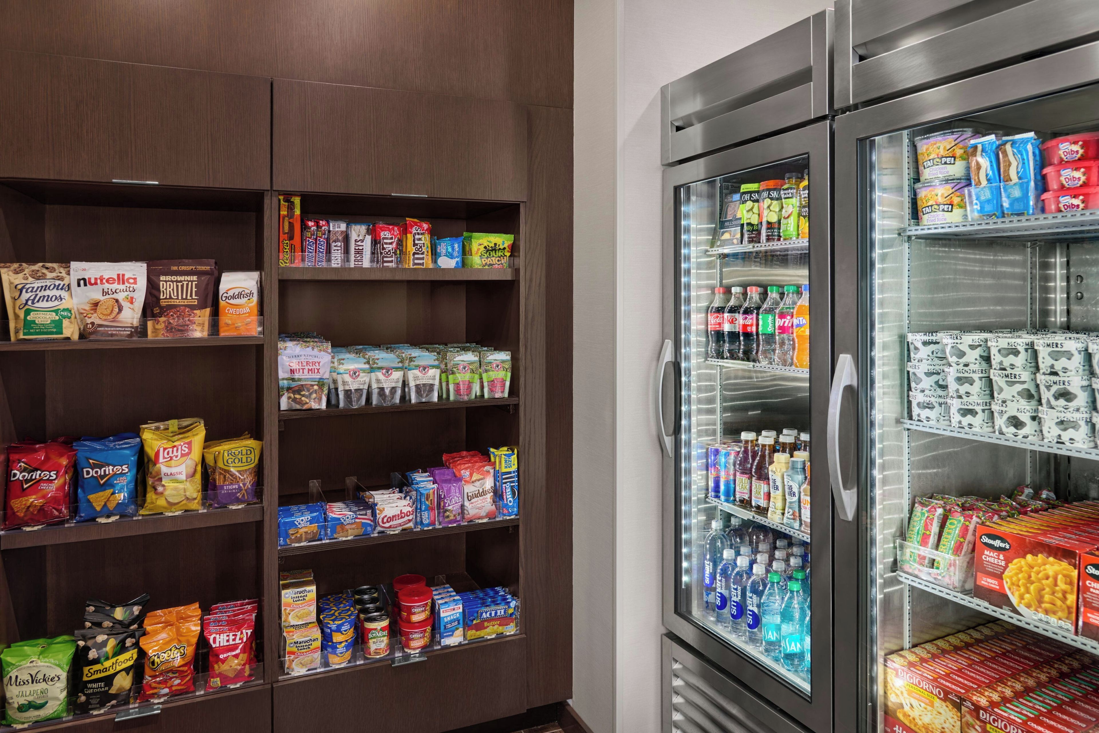 Eine Auswahl an Snacks und Getränken in Hotelgastronomie, darunter verschiedene Chips, Kekse und abgefüllte Getränke.
