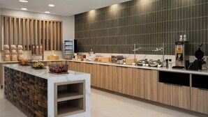 A modern kitchen with a marble island, wooden accents, and various appliances. - Fairfield By Marriott Inn & Suites Corbin (Corbin)