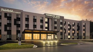 A Marriott hotel with a modern facade, labeled 'Fairfield' and 'Towneplace Suites,' featuring a well-lit entrance and a parking area. - Fairfield By Marriott Inn & Suites Corbin (Corbin)