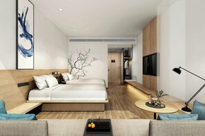 A modern hotel room with a bed, a sofa, a small table with drinks, and a TV. - Fairfield By Marriott Yancheng Dafeng (Yancheng)