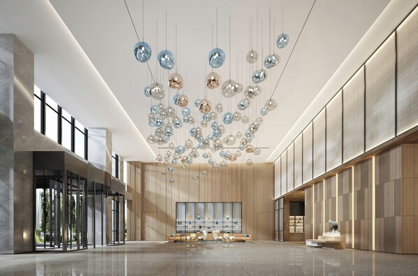 A spacious lobby with a modern design, featuring a large seating area, a reception desk, and a unique ceiling light fixture. - Fairfield By Marriott Yancheng Dafeng (Yancheng)