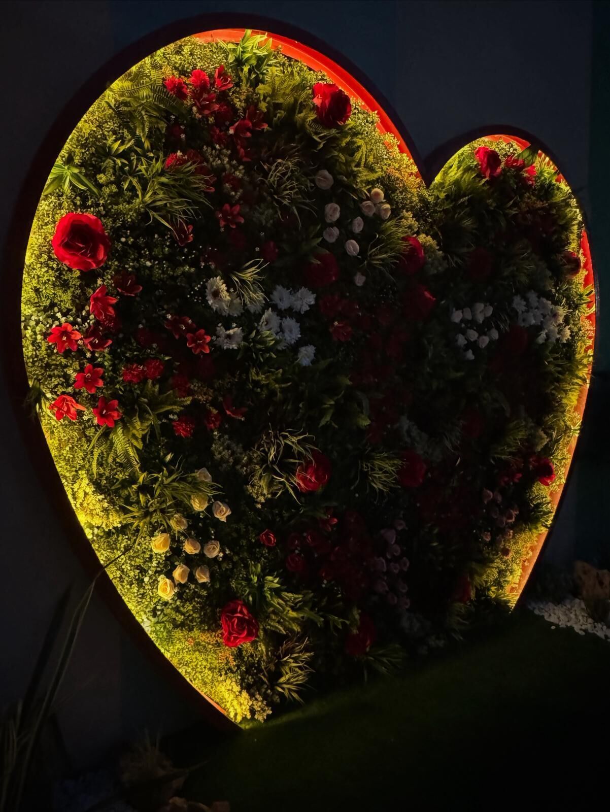 A heart-shaped floral arrangement with a warm glow.