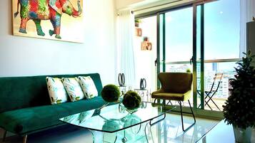 Deluxe Apartment, Balcony, City View | Living area | 55-inch LED TV with digital channels