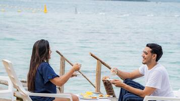 On the beach, white sand, sun loungers, beach umbrellas