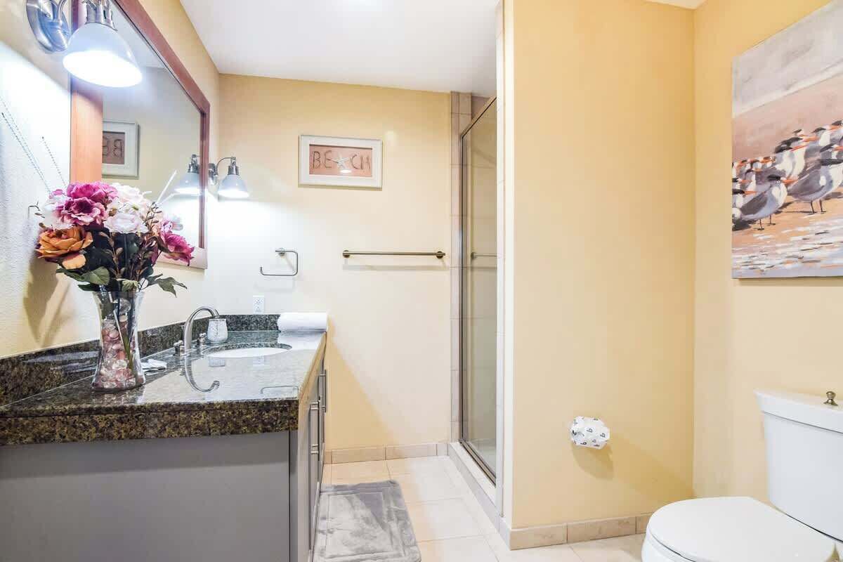 A bathroom with a sink, mirror, and toilet.