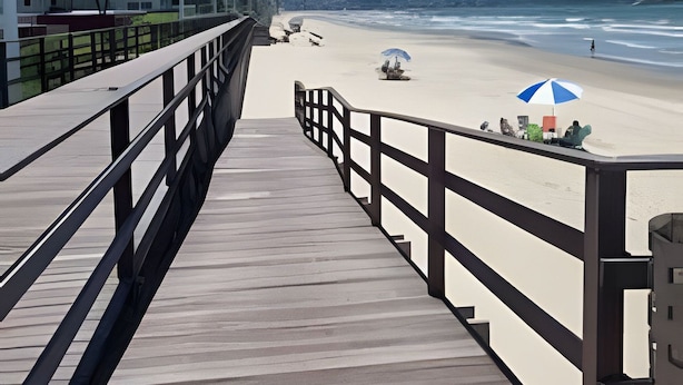 A wooden boardwalk leading to a beach with a blue and white umbrella. - Apartamento Itapema (Itapema)