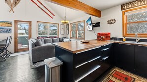 A modern kitchen with a wooden ceiling, large windows, and a view of the outdoors. - 3B/2BA + Loft | Eagle-Vail• Dog-Friendly (Avon)