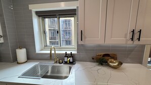 A kitchen with a window, a sink, and a countertop. - Downtown Gem, Sunset & City Views, fully renovated (Atlanta)