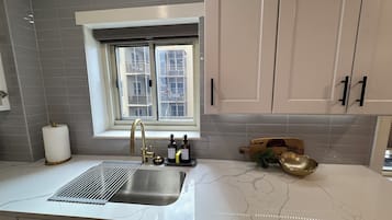 A kitchen with a window, a sink, and a countertop.