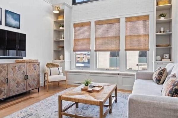 Soaring 14-foot ceilings + natural light create an open, airy retreat in downtown Muncie.