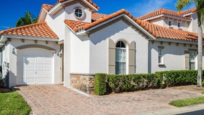 A two-story house with a white exterior, a red-tiled roof, and a garage. - 293 - Fabulous 3 Bed Villa with Private Oversized Pool (Davenport)