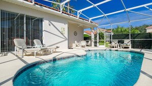 A swimming pool with lounge chairs, a covered patio, and a view of the surrounding area. - 293 - Fabulous 3 Bed Villa with Private Oversized Pool (Davenport)