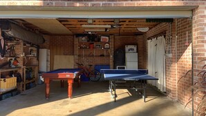A garage with a pool table, a bicycle, and various tools and equipment. - Surfrise manyana the surfers temple.sunrise ocean views native wildlife, (Manyana)