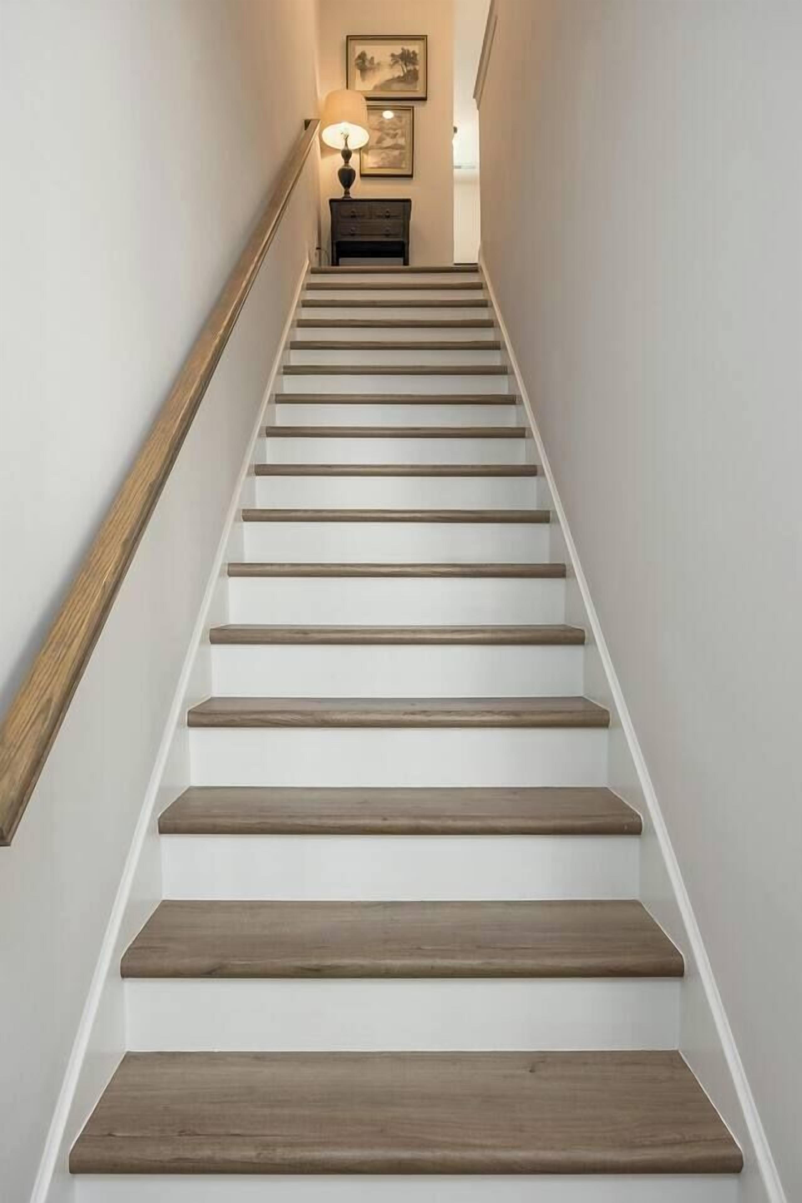 A staircase with wooden steps and white walls.