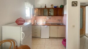 A compact kitchen with a sink, cabinets, and a window. - 1 bedroom awesome apartment in Gradac (Gradac)