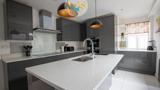 A modern kitchen with grey cabinets, a white countertop, a stainless steel sink, and pendant lighting. - The Laurels - HS2 Contractors, NEC, BHX Airport Stays, Sleeps 12, Free Parking (Birmingham)
