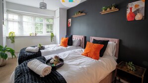 A modern bedroom with two beds, a large window, and decorative plants. - The Laurels - HS2 Contractors, NEC, BHX Airport Stays, Sleeps 12, Free Parking (Birmingham)