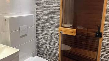 Shower, hair dryer, towels, toilet paper