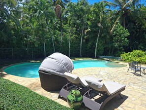 A backyard with a swimming pool, lounge chairs, and a grill. - Villa in Sea Horse Ranch, Cabarete's Most Exclusive Oceanfront Gated Community! (Sosúa)