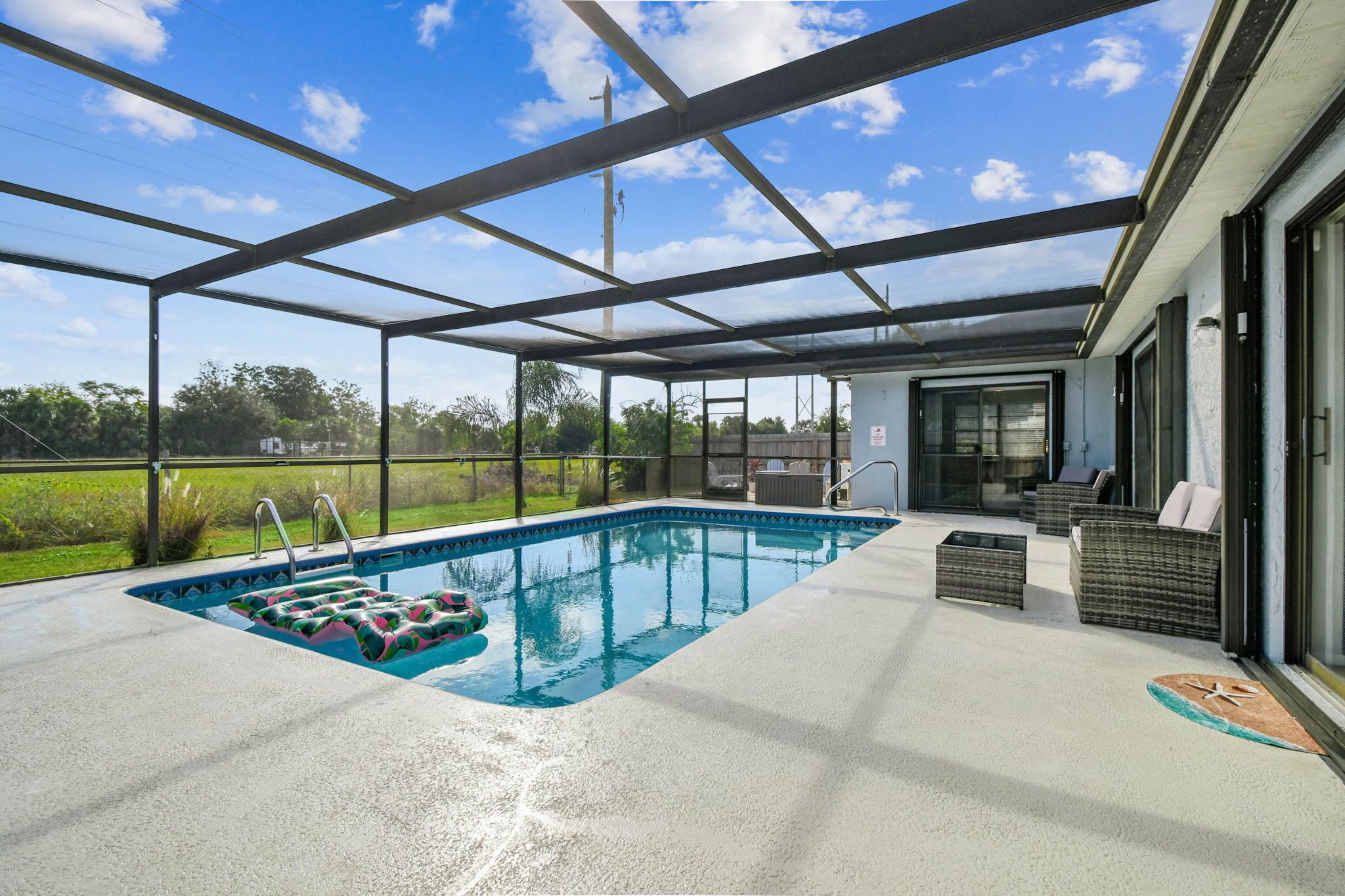 A covered outdoor swimming pool with a view of the surrounding landscape.