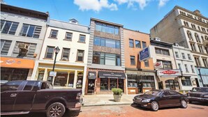 A street view with a building labeled "Campbell & Company" featuring a large window and a potted plant outside. - Modern & Cozy 2-bedroom condo in Center City Philadelphia - Walk Everywhere (Philadelphia)