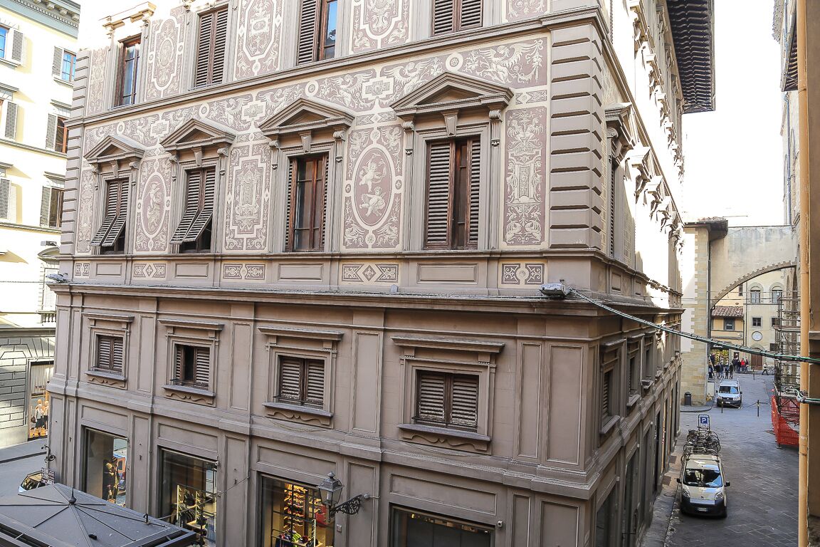 A multi-story building with ornate architectural details, including decorative moldings and shutters.