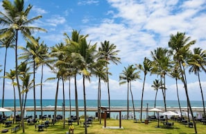 On the beach, white sand, sun loungers, beach umbrellas