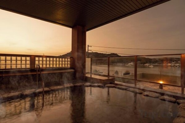 A hot spring area with a view of the water and hills.