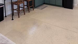 A modern kitchen with a marble countertop, wooden chairs, a black refrigerator, and decorative items on shelves. - Pet-Friendly Mountain Studio - Cozy Stay with Patio & Covered Private Parking (Kingsport)