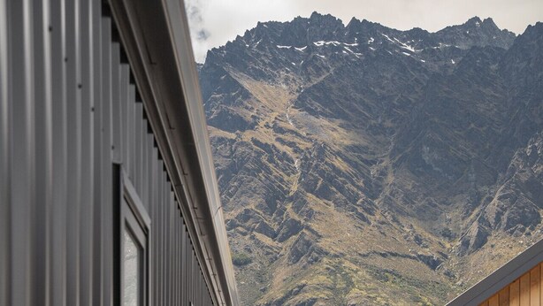 A corridor with a view of a mountain range.