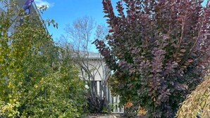 A garden pathway with stepping stones leading to a house. - Comfortable, Spacious home with pool table•firepit• great location (South Jordan)