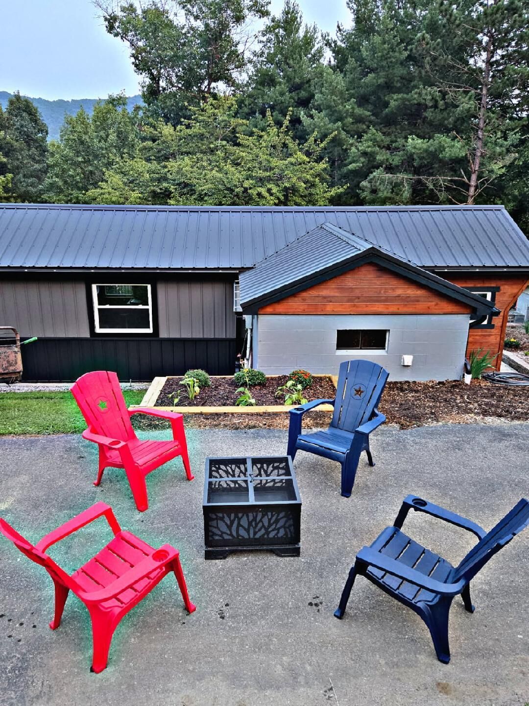 A patio area with outdoor furniture and a building with a metal roof.