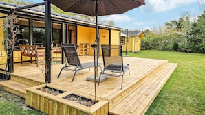 A wooden deck with outdoor seating, a pergola, and a small building. - 2 bedroom awesome home in Tarm (Tarm)