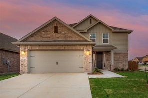 A two-story house with a garage, brick facade, and a number '3531' on the garage door.