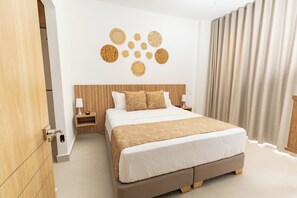 Una camera da letto moderna con un letto grande, una testiera in legno e una parete decorata con elementi circolari.