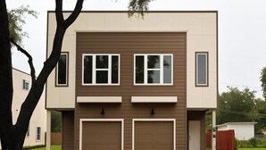 A modern two-story house with a garage, a front yard, and a tree. - Modern 3BR Home w/Private Yard + Garage (Houston)