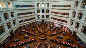 A multi-level library with numerous bookshelves and seating areas. - Marvellous Views - Bright & Spacious CBD Escape (Melbourne)