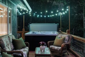 A cozy outdoor seating area with wicker furniture, a hot tub, and string lights. - Fall Foliage • Views • Hike Appalachian Trail • Ski Hatley & Explore Asheville (Mars Hill)